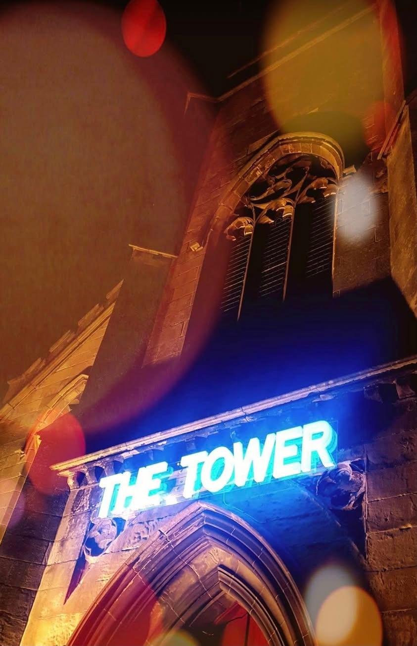 THE TOWER sign lit up at night